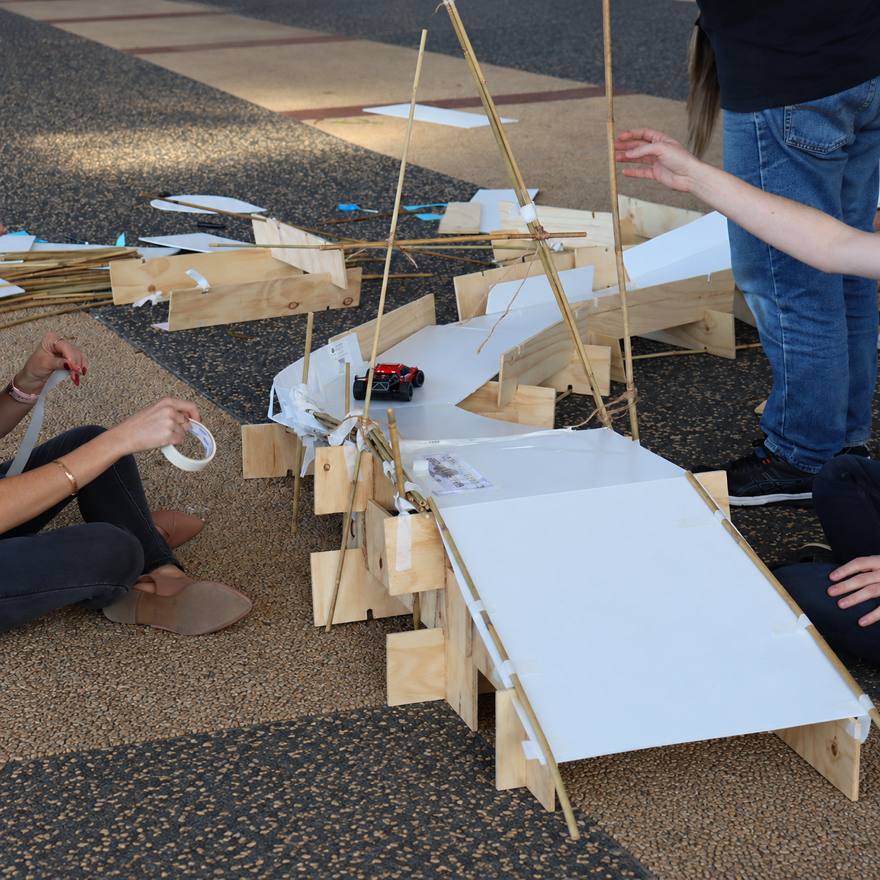 Team constructing and testing a bridge