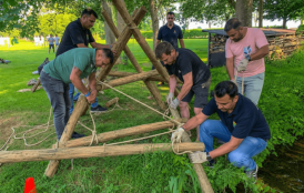 Corporate team completing a supervised outdoor trust fall